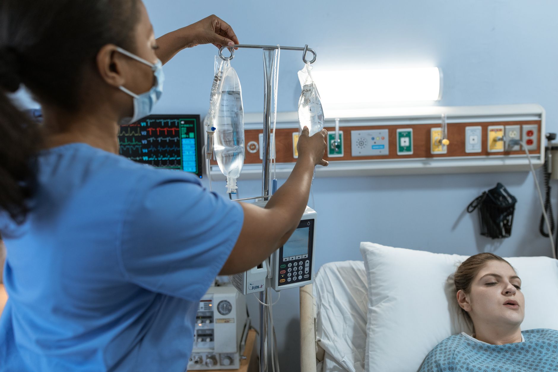 nurse fixing a patient s dextrose bags